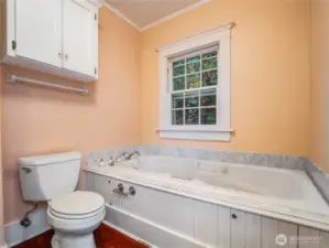 Large jetted tub, walk-in shower and bead board ceiling in the primary bathroom.