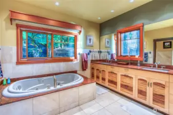 Same custom spalted maple cabinets, granite counters and soaking tub highlight the primary bath.