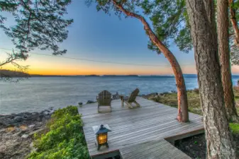 Sunsets will entrance you, whether from the interior of the home or perched on the deck just above the waves.