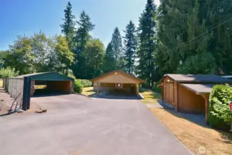 Gated entry, extra covered parking and storage shed towards front of property. Yard is fully fenced to protect littles and animals from direct access to river.