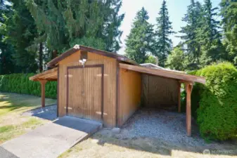 Storage shed with lean tos on each side.