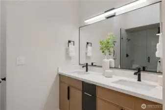 Dual sink vanity & porcelain tile floors.