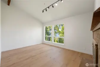 Large den with fireplace and beautiful lake views.
