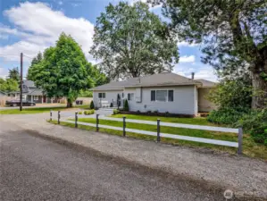 Property extends past fence on left side, up to road