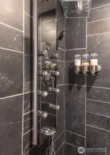 This walk in shower has multiple shower spray.