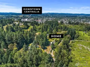 Enjoy the best of both worlds—this aerial view shows the peaceful property setting with a clear perspective of nearby Centralia, just a short drive away for shopping, dining, and community events.
