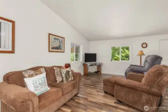 With vaulted ceilings, natural light, and an open layout, this living room is perfect for hosting guests.