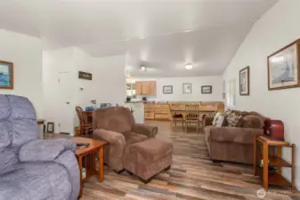 Open dining area flows seamlessly from the kitchen into the living room with views of the natural surroundings.