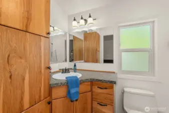 The primary bath includes beautifully upgraded cabinetry for a polished, functional space.