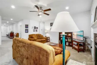 Standing in the dining room, we're looking toward the living room and entry of the primary bedroom.