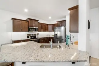 When guests arrive, the raised island is a great place for them to enjoy your cooking!