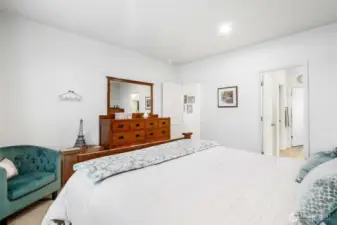 Another view of the primary bedroom shows you the way into the bathroom.