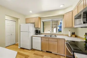 Kitchen with peninsula; stove (2017) and microwave (2023).