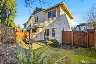 Back exterior with fenced yard and patio.