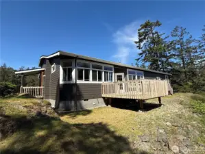 View of the back side of the home and fabulous deck space for outdoor entertaining and dining.