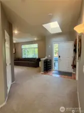 Standing in the entry and looking towards the front door. The door to the left is a walk-in coat closet. Perfect to accommodate a whole house full of Pacific Northwest winter gear and boots and more!