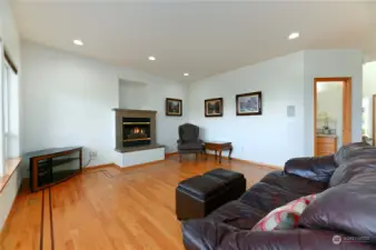 living room with gas fireplace. Half bathroom on the right