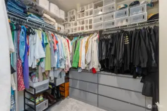 This expansive walk-in closet offers ample storage and organization for all your wardrobe needs. and plenty of hanging space. This closet provides the perfect solution for keeping clothing, shoes, and accessories neatly arranged. The thoughtful design allows for easy access to everything, while overhead shelving offers additional storage for seasonal items. Spacious and practical, this walk-in closet is a dream for anyone who loves to stay organized while maintaining a stylish and clutter-free space.