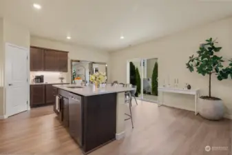 The open layout flows effortlessly into the dining area, where sliding glass doors lead to a private patio, making indoor-outdoor living a breeze. With plenty of natural light and modern finishes throughout, this kitchen offers the perfect balance of practicality and elegance.