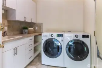 Laundry room w/ exterior door to courtyard that leads to detached garage.