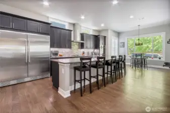 Chef's kitchen with large island and oversize refrigerator