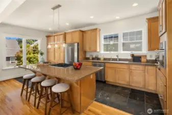Open layout kitchen with plenty of cabinet storage and convenient breakfast bar