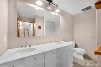 Lower level full bathroom with new vanity, sinks and and flooring.