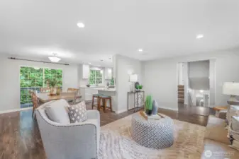 Looking back toward the kitchen and dining spaces, you can see how the living room integrates beautifully with the heart of the home. This connected design enhances both everyday living and entertaining.