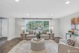 Another angle of the living room emphasizes its generous size and central location. Whether relaxing or hosting, this is a versatile space that adapts to your needs.