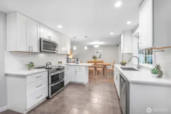 From this angle, the kitchen showcases its thoughtful layout, with generous counter space and storage. Overlooking the dining area, it encourages connection while meals are being prepared.