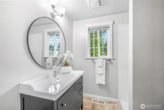 The private three-quarter bath in the primary suite features updated finishes, a modern vanity, and a window for natural light. A comfortable space designed for convenience.