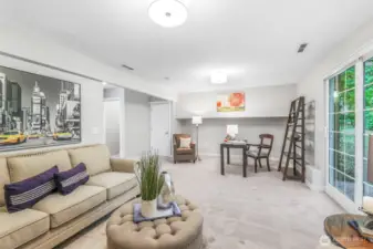 Another view of the family room emphasizes its open feel and natural light from sliding glass doors. This lower-level retreat offers a perfect place for both relaxation and play.