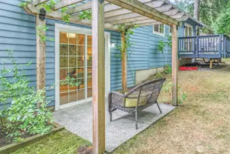 Another angle of the pergola highlights its connection to the home through sliding glass doors. This thoughtful design expands the living area into the backyard.