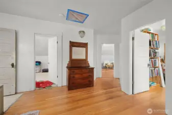 A view of the three upstairs bedrooms from the landing.  The upstairs bathroom is on the left. Drywall and paint have already been taken care of upstairs.