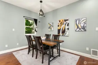 Dining area features unique designer lighting and space to accommodate large tables.