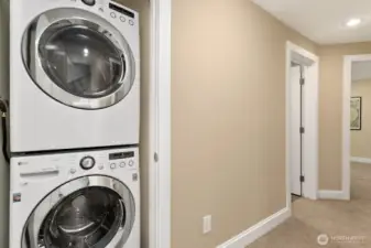 Tucked neatly into the lower-level hallway, the stacked LG washer and dryer offer modern convenience without sacrificing space.