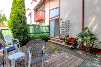 The patio can be accessed from the sliders off the dining room or you can follow the side yard pathway from the front door.