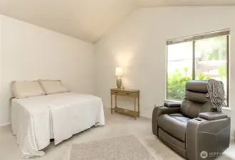 The primary bedroom has two corner windows, both that open and have screens.  Vaulted ceiling too.