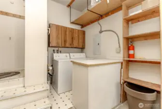 The laundry room in garage has custom made cabinetry adjacent to it for folding clothes.  The gas furnace is next to the appliances.