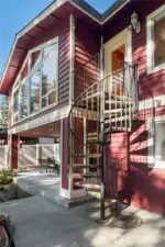 Charming spiral staircase leads to the laundry room