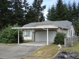 Front elevation.  Note the 2 car carport in addition to the 2-car garage.