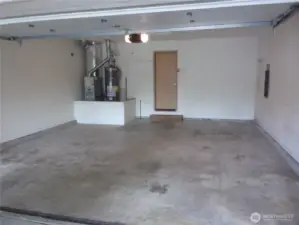 Fully sheet rocked garage with garage door opener.