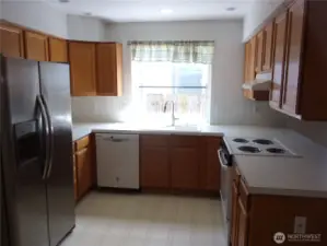 U-shaped step saver kitchen with garden window over the double sink.