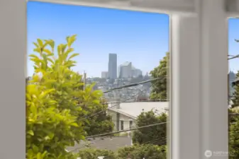Peek views of downtown Seattle, lake, Seward Park & Mountains