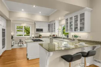 Spacious kitchen with quality appliances, plenty of storage, counter tops and two nooks on either side.  This one is looking into the den.
