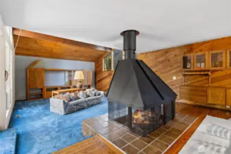 sunken living room with 360* gas fireplace.
