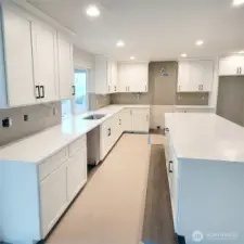Light & bright kitchen with quartz countertops, full tile back splash.