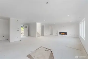 Great room with electric fireplace.  LVP for all flooring on the main floor.