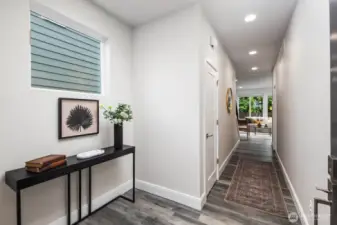 Entryway with coat closet and room for a bench.