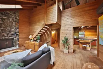 living area with view of stairs to loft